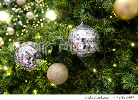 Christmas background of de-focused lights with decorated tree 72458444