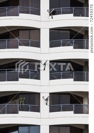 satellite dishes on house with balconies 72459378