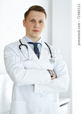 Doctor man standing straight in medical office or clinic. Medicine concept 72460121