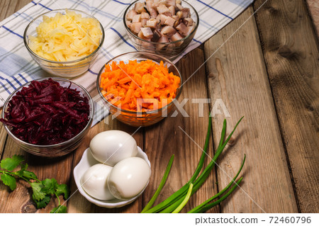 Ingridients for russian salad. Potatoes, carrots, herring, eggs placed on the table. Ready for cooking. Ingridients for russian salad. Potatoes, carrots, herring, eggs placed on the table. Ready for cooking. 72460796