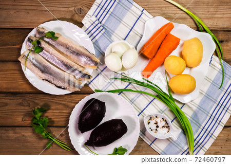 Ingridients for russian salad. Potatoes, carrots, herring, eggs placed on the table. Ready for cooking. 72460797