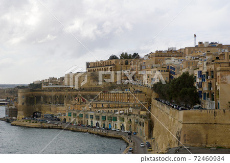 VALLETTA, MALTA - DEC 31st, 2019: Panoramic skyline view of the Grand Harbor of Valletta and Upper Barrakka Gardens at daylight with blue sky during winter 72460984