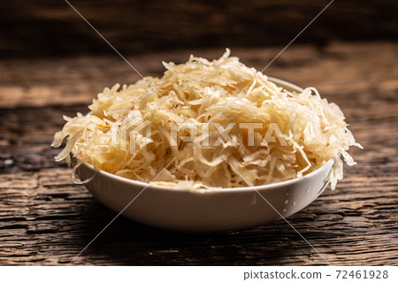 A bowl full of raw sauerkraut cabbage pickle on a A bowl full of raw sauerkraut cabbage pickle on a 72461928