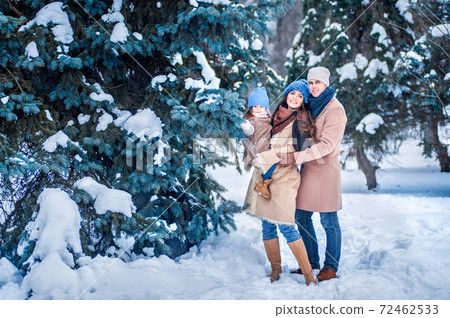 portrait of a family against the background of snow-covered trees 72462533