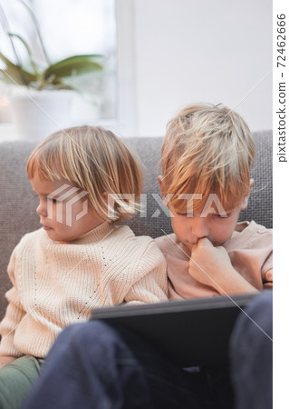 Brother and Sister Watching Videos via Tablet 72462666