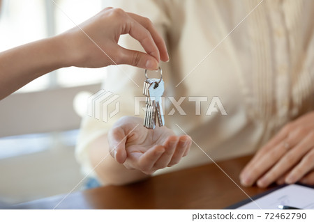 Close up of realtor give keys to female renter 72462790