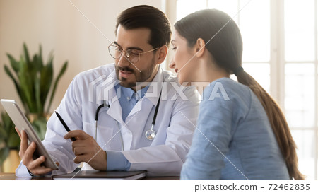 Banner view of male doctor and female patient use tablet Banner view of male doctor and female patient use tablet 72462835
