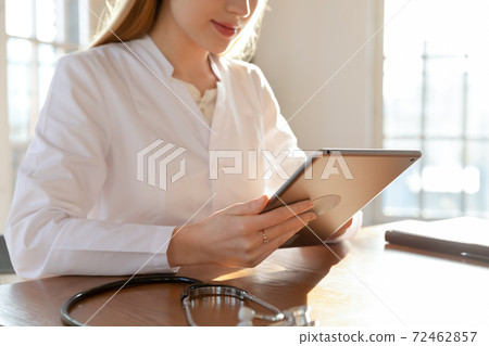 Close up of female doctor use tablet consulting client Close up of female doctor use tablet consulting client 72462857