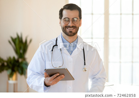 Portrait of smiling male doctor using tablet Portrait of smiling male doctor using tablet 72462858