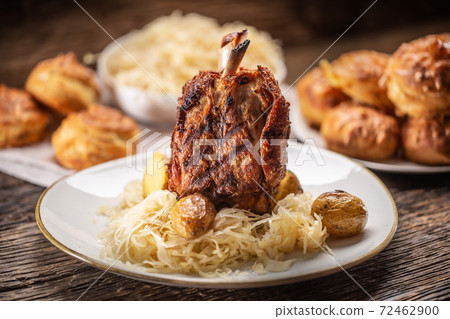 Baked pork knuckle served with sauerkraut and baked pastry 72462900