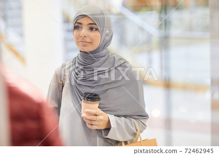 Young Woman Looking at Displays in Shopping Mall 72462945