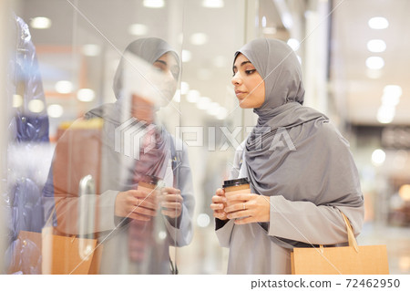 Young Middle-Eastern Woman Looking at Shop Display 72462950
