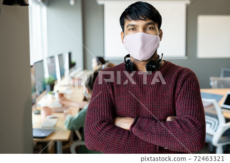Young male in protective mask and casualwear crossing arms on chest 72463321