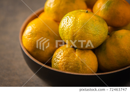 Tangerines or mandarines in bamboo bowl close up Tangerines or mandarines in bamboo bowl close up 72463747