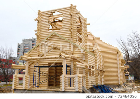 Construction of a Christian church made of wooden treated logs Construction of a Christian church made of wooden treated logs 72464056