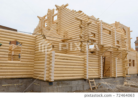 Construction of a Christian church made of wooden treated logs Construction of a Christian church made of wooden treated logs 72464063