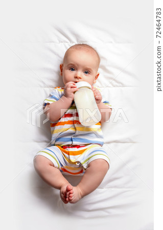 Baby with baby milk bottle. Top view. 72464783