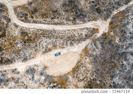 Aerial photograph of a dirt track and a forest after bushfires in regional Australia 72467154