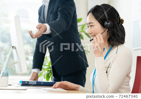 A woman working at a call center A woman working at a call center 72467340