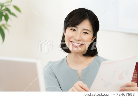A woman working on a computer A woman working on a computer 72467698