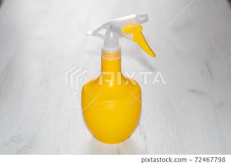 Yellow spray bottle for ironing clothes on white background 72467798