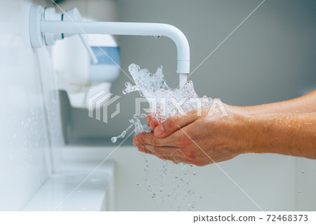 hands under the faucet with splashing water hands under the faucet with splashing water 72468373