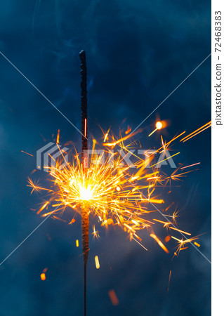 fire sparkler in dense smoke, abstract Christmas firework background 72468383