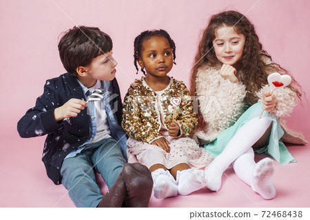lifestyle people concept: diverse nation children playing together, boy and girl, caucasian and african american 72468438