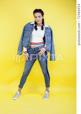 lifestyle people concept: pretty young school teenage girl having fun happy smiling on yellow background lifestyle people concept: pretty young school teenage girl having fun happy smiling on yellow background 72468454