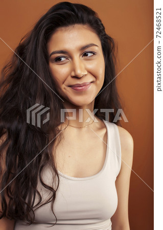 young pretty girl with curly hair posing cheerful on brown background, lifestyle people concept young pretty girl with curly hair posing cheerful on brown background, lifestyle people concept 72468521