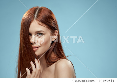 Beautiful brunette long hair naked shoulders cosmetics charm health care blue background Beautiful brunette long hair naked shoulders cosmetics charm health care blue background 72469614