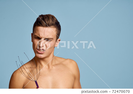 Happy man with head massager on blue background cropped view close up portrait Happy man with head massager on blue background cropped view close up portrait 72470070