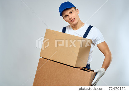 working man in uniform with boxes in his hands delivery loader lifestyle 72470151