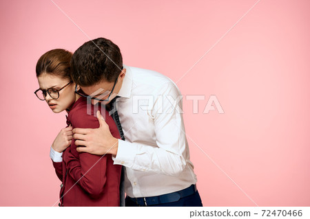 Work colleagues communication emotions officials office pink background 72470466