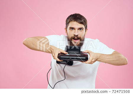 Man with prefix in hand joystick games lifestyle fun pink background white t-shirt 72471508