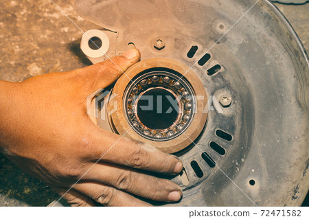 Hand of Car Mechanic or Auto Mechanic Hold Car Bearing Housing in Vintage Tone 72471582