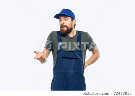 Worker man uniform delivery service emotions studio light background Worker man uniform delivery service emotions studio light background 72472933