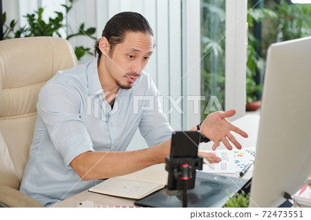 Graphic designer filming himself Graphic designer filming himself 72473551