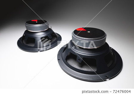 Two new car speakers on a white background in contrasting light. Wide angle audio background 72476004