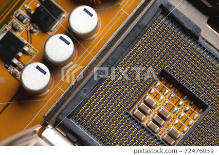 Blank cpu cpu socket with pins on motherboard in yellow color close-up Blank cpu cpu socket with pins on motherboard in yellow color close-up 72476039