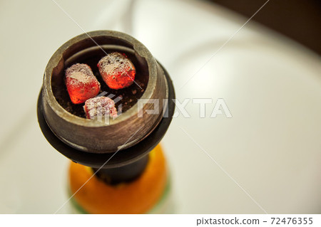 Red coals in a hookah. Close-up, selective focus 72476355