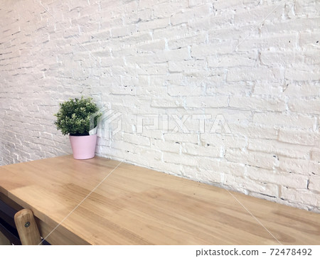 Green plastic tree in the pink pot set decor on the wooden table and white wall background. Green plastic tree in the pink pot set decor on the wooden table and white wall background. 72478492