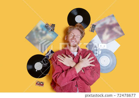 Ginger smiling man lying near the records and feeling good 72478677