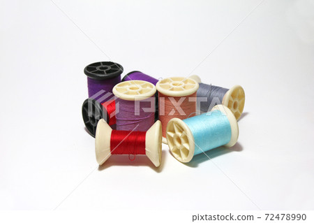 Heap of colorful thread in the thread roll on white background. 72478990