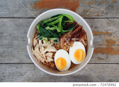 Boiled instant noodles with boiled egg, fish meat, green leafy vegetables and pickle lettuce Boiled instant noodles with boiled egg, fish meat, green leafy vegetables and pickle lettuce 72478992