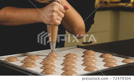 Chef making base for preparation macaron dessert. 72479304
