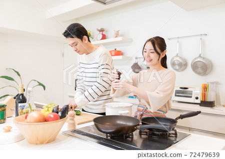 Young newlyweds making meals 72479639
