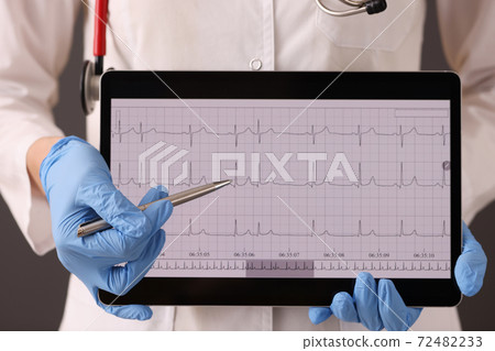 Doctor in rubber gloves holding digital tablet with cardiogram closeup 72482233