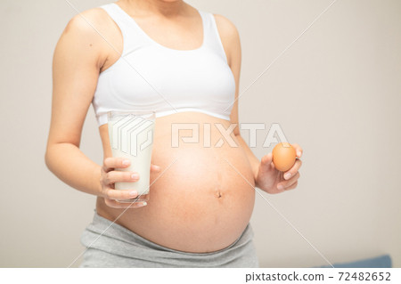 Young woman asian choose eating healthy food,eggs and milk during her pregnancy Young woman asian choose eating healthy food,eggs and milk during her pregnancy 72482652