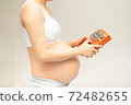 A pregnant woman plays a kalimba instrument for her unborn child to listen. Music is something that will help your baby's brain development 72482655